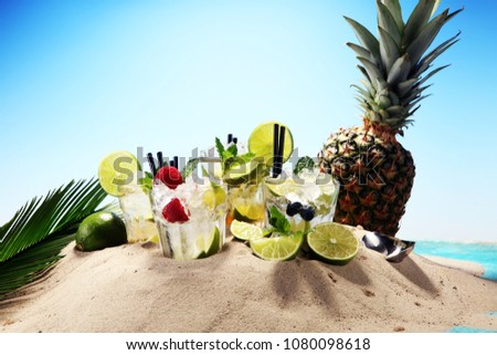 Different types of mojito cocktail on the beach