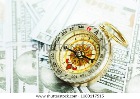 compass on pile of US money