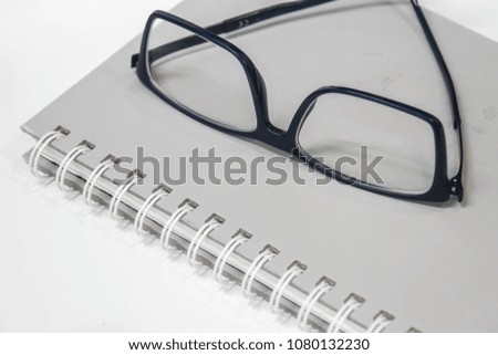 men modern minimal eye glasses on notebook for reading and writing in office