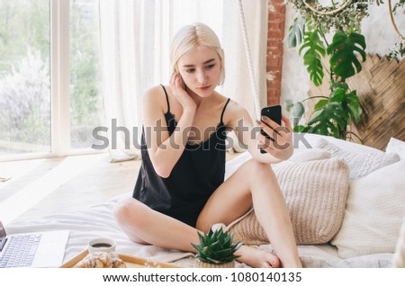 A young girl does selfie on the phone