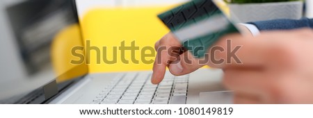 Male arms hold credit card press buttons making transfer closeup. Anti-fraud financial security when entering client discount program number or filling personal credential password login to account