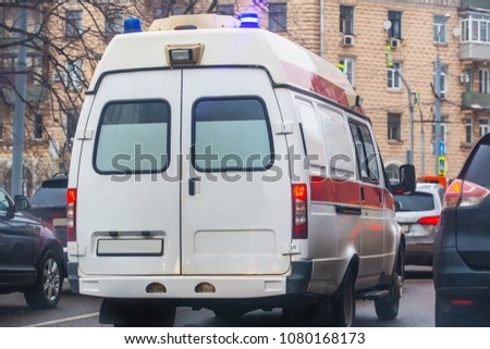 ambulance on the city street in a traffic jam