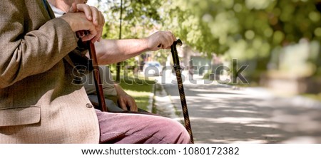 Concept of a retirement age - pensioners, friends sitting in the park and resting Royalty-Free Stock Photo #1080172382