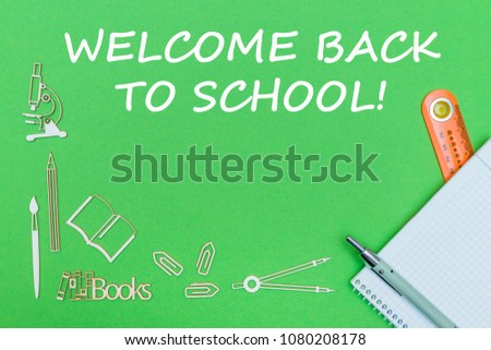 concept school, text welcome back to school, school supplies wooden miniatures, notebook with ruler and pen on green backbord