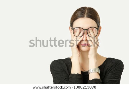 Portrait of young woman rubs her tired eyes Royalty-Free Stock Photo #1080213098