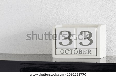 White block calendar present date 33 and month October on white wall background - Extra day