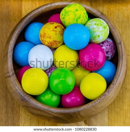 colorful various round candy yellow blue bright dessert in a wooden bowl close-up