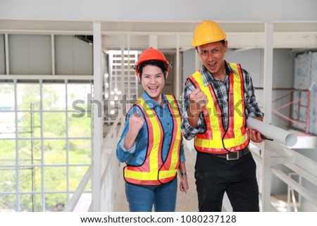 portrait engineer people show wining symbol after finish successful project at construction site, using as background (concept of teamwork and partnership)