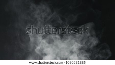 vapor steam rising over black background Royalty-Free Stock Photo #1080281885