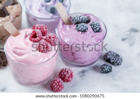 Healthy vegan dessert concept - smoothie bowl made of frozen banana and berries Royalty-Free Stock Photo #1080290675