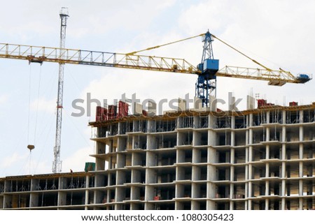 Construction site background. Crane over concrete building.