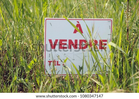 sign indicating that land is for sale in a rural area