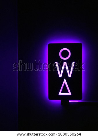 Female public toilet led light sign. beautiful purple light restroom sign in modern style.