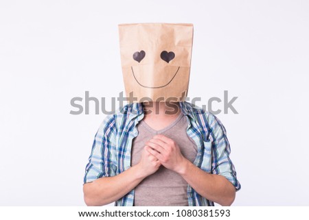 Love, emotion and relationship concept - Man with cardboard box on his head with enamored face.