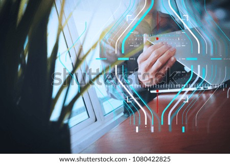 Business data analytics process management diagram.designer hand working laptop with green plant foreground on wooden desk in office

