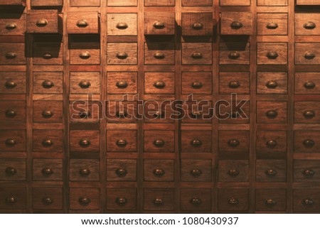 Old wooden textured drawers background in chinese herbal medicine shop in china.Vintage asian objects. Royalty-Free Stock Photo #1080430937