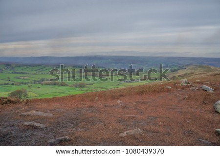 Moors with heather smoke clouds in the skyline