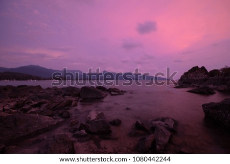 silhouette of rock formations in the sea during Twilight.Long Exposure Photography Technique .Chai Chet, Koh Chang, Trat, Thailand.