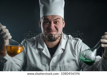 guy in white robe chemist with flasks reagents 
