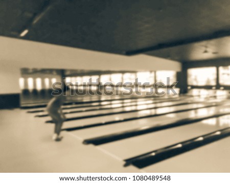 Vintage blurred bowling lane alley with bowler throwing the ball