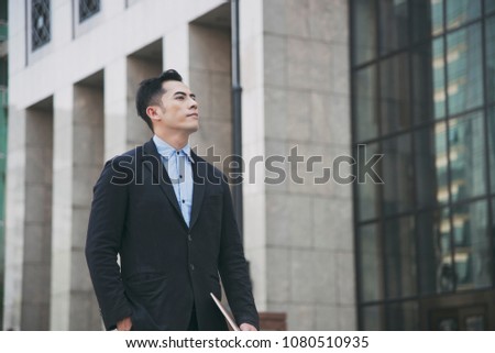 young asian businessman handsome looking for something.