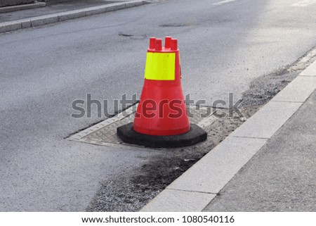 Traffic cone on a manhole outdoor in traffic