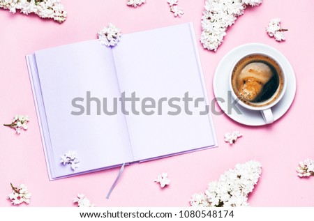 Flat lay and mock up of Notebook and cup of coffee and lilac flower. Romantic spring picture. Top view, Place for your text. Copyspace.