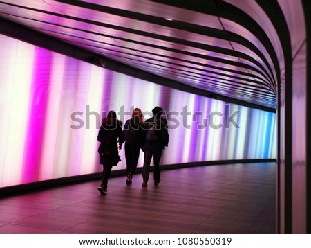 Three commuters in the Kings Cross Tunnel
