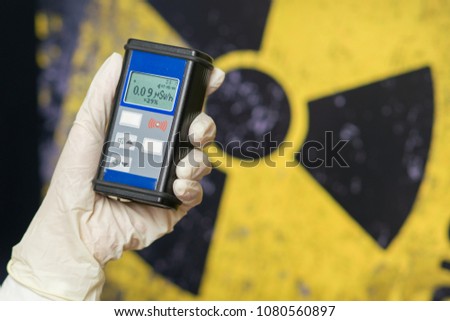 Radiation supervisor in glove with geiger counter checks the level of radiation in the radioactive zone Royalty-Free Stock Photo #1080560897