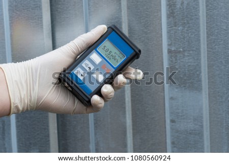 Radiation supervisor in glove with geiger counter checks the level of radiation in the radioactive zone Royalty-Free Stock Photo #1080560924