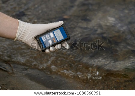 Radiation supervisor in glove with geiger counter checks the level of radiation in the radioactive zone Royalty-Free Stock Photo #1080560951