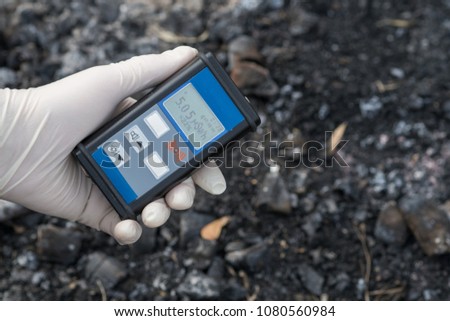 Radiation supervisor in glove with geiger counter checks the level of radiation in the radioactive zone Royalty-Free Stock Photo #1080560984