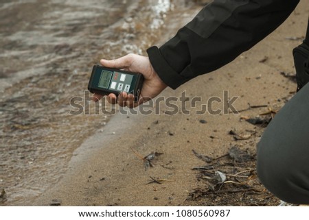 radiation supervisor with geiger counter checks the level of radioactive radiation in the danger zone Royalty-Free Stock Photo #1080560987