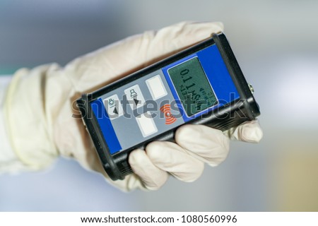 radiation supervisor with geiger counter checks the level of radioactive radiation in the danger zone Royalty-Free Stock Photo #1080560996