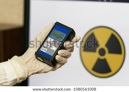 Radiation supervisor in glove with geiger counter checks the level of radiation in the radioactive zone Royalty-Free Stock Photo #1080561008