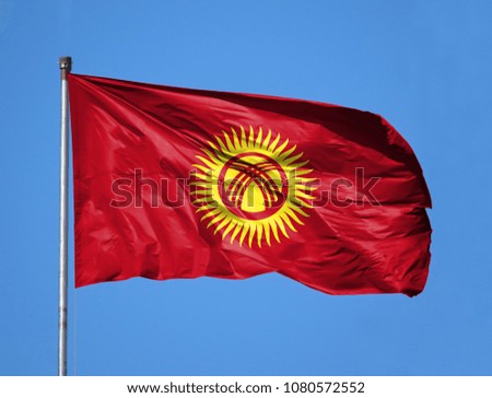 National flag of Kyrgyzstan on a flagpole