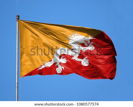 National flag of Butane on a flagpole