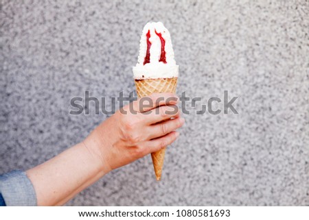 Female hand holding ice cream in waffle cone. Summer time,  ice cream day