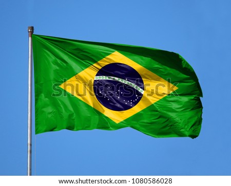 National flag of Brazil on a flagpole in front of blue sky Royalty-Free Stock Photo #1080586028