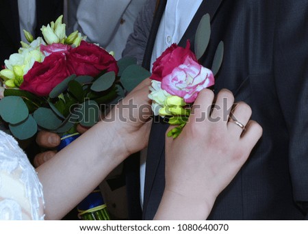 Female hands correct a wedding flower