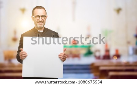 Priest religion man holding blank advertising banner, good poster for ad, offer or announcement, big paper billboard at church