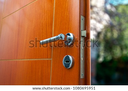Open door of a family home. Close-up of the lock an armored door.