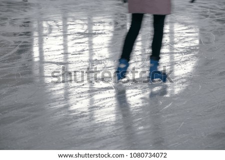 skater and reflection on ice rink from glass in the form of heart