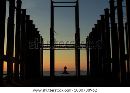 silhouette of construction site and silhouette of buddha during sunset at the sea, Landscape of abandoned buildings in the sea with colorful sky