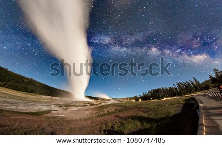 Old Faithful in Yellowstone National Park erupting under the Milky Way in Wyoming. Royalty-Free Stock Photo #1080747485