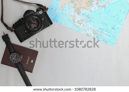 Top view accessories travel with passport,camera,watch on map background