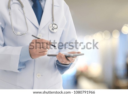 Doctor using smartphone communicate with patient at the doctor office. Medical technology concept.