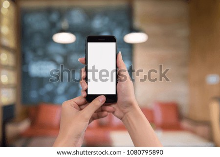 Cropped shot view of woman's hands holding smart phone with blank copy space screen for your text message or information content.