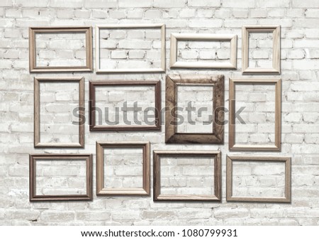 old photo frames on brick wall