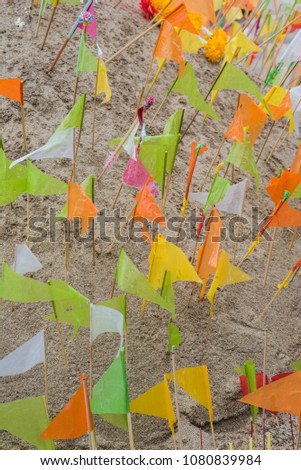 Colorful paper flags on the pile of sand  in Songkran festival in Thailand.